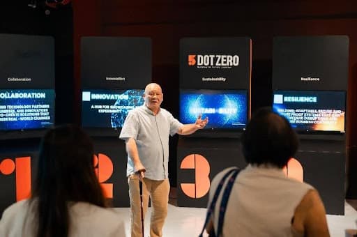 A presenter introducing the five pillars of 5 Dot Zero.